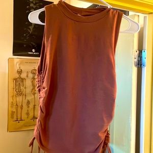 Pink top with draw strings on each side.